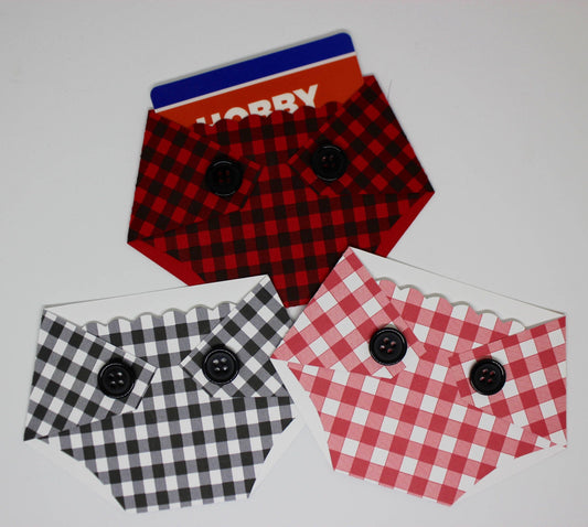 Three plaid-patterned, diaper-shaped gift card holder with a red, black and white checkered designs and black buttons, designed to hold a standard gift card.