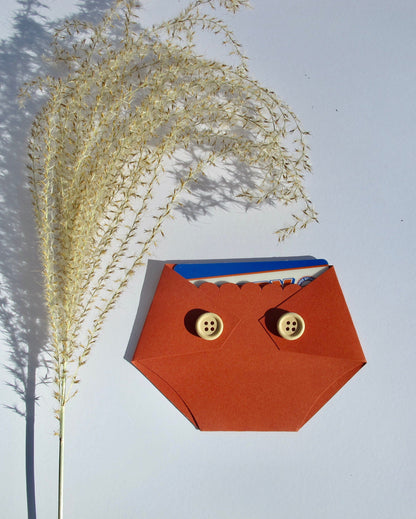 burnt orange rust colored diaper shaped gift card holder with light brown wooden buttons