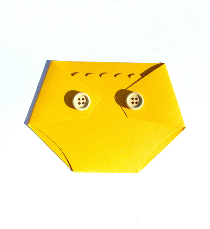 golden yellow diaper shaped gift card holder with light brown wooden buttons