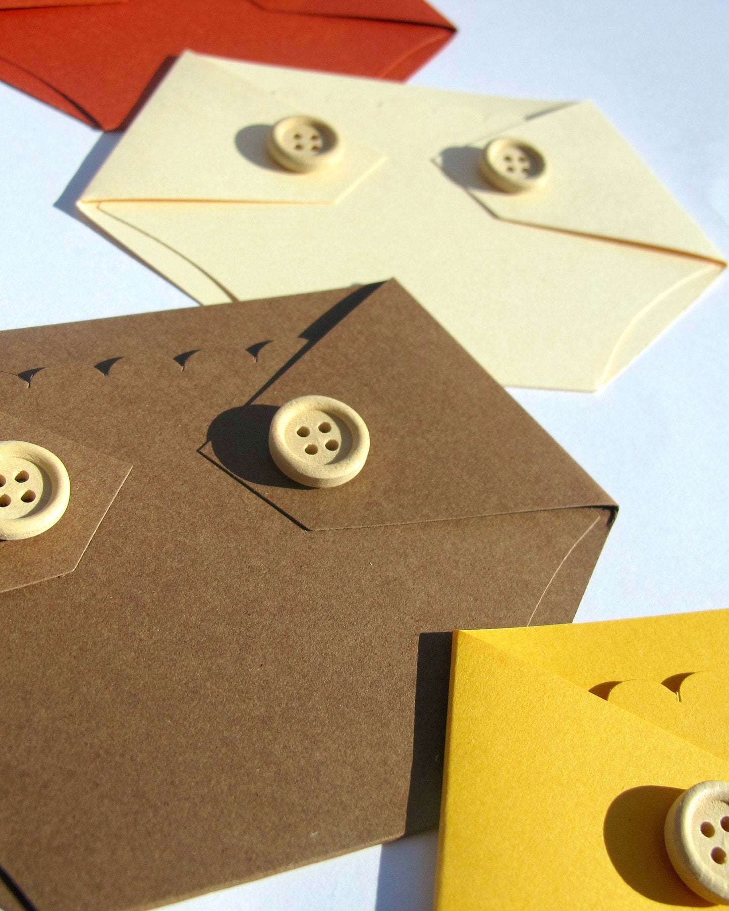 up close view of the wooden buttons on the diaper shaped gift card holders