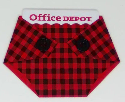 A plaid-patterned, diaper-shaped gift card holder with a red and black checkered design and black buttons, designed to hold a standard gift card.