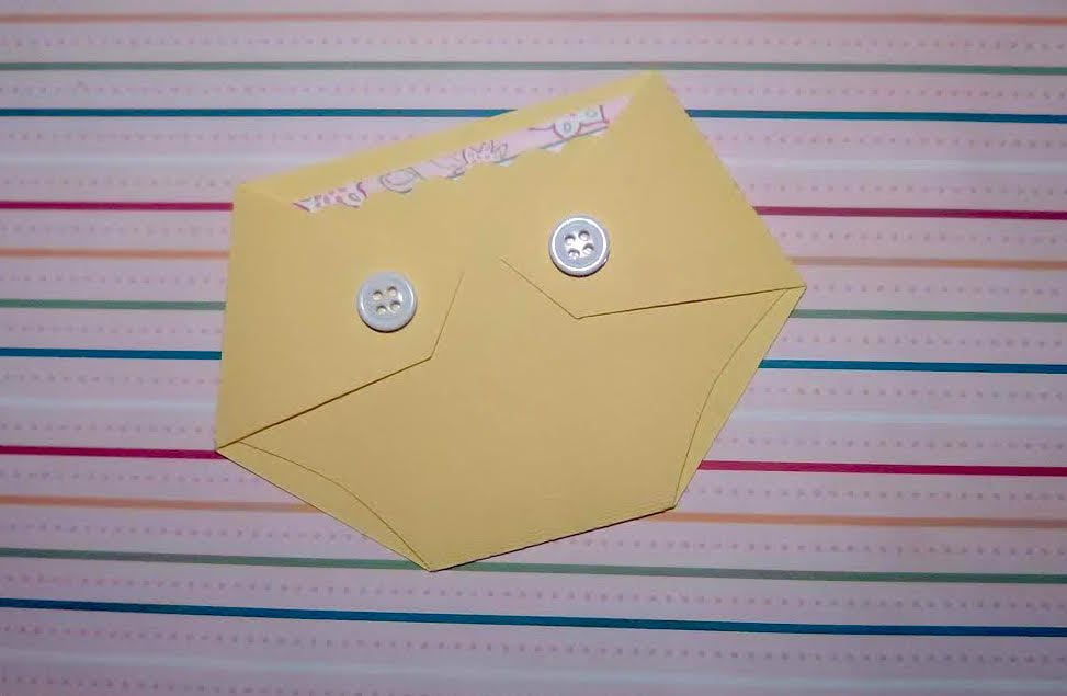 yellow diaper shaped gift card holder with white buttons